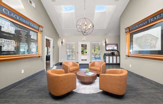 A waiting area with brown chairs and a sign that says Clackamas Trails at Clackamas Trails Apartments, Oregon, 97222