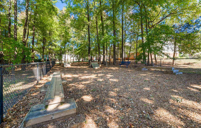 A park with a bench and trees.