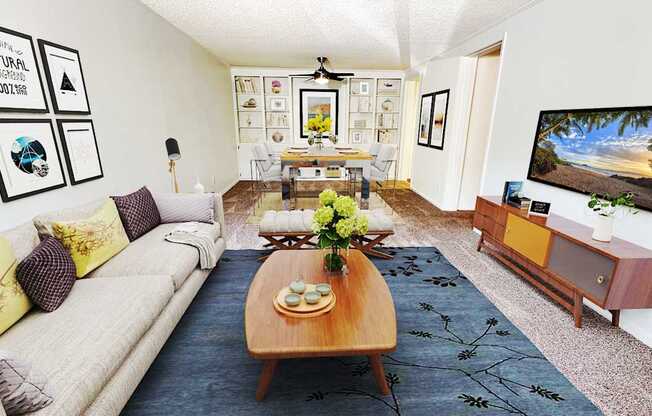 A living room with a couch, coffee table, and pictures on the wall.
