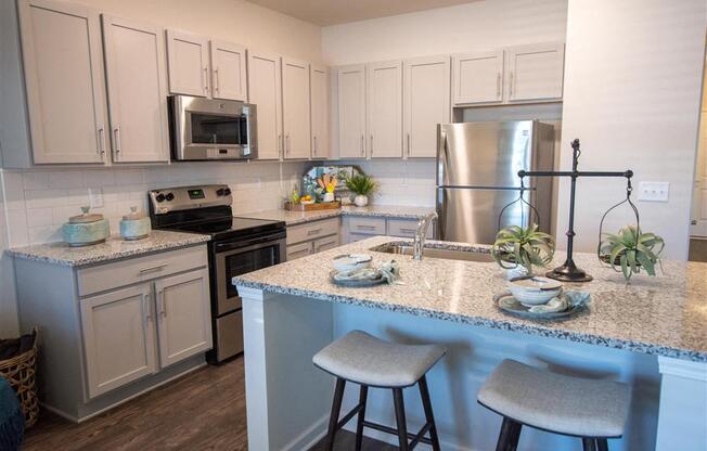 a kitchen with granite counter tops and stainless steel appliances