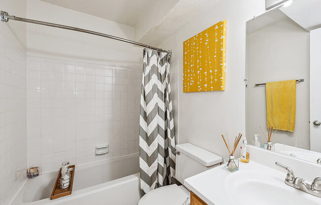 a white bathroom with a shower curtain and a sink