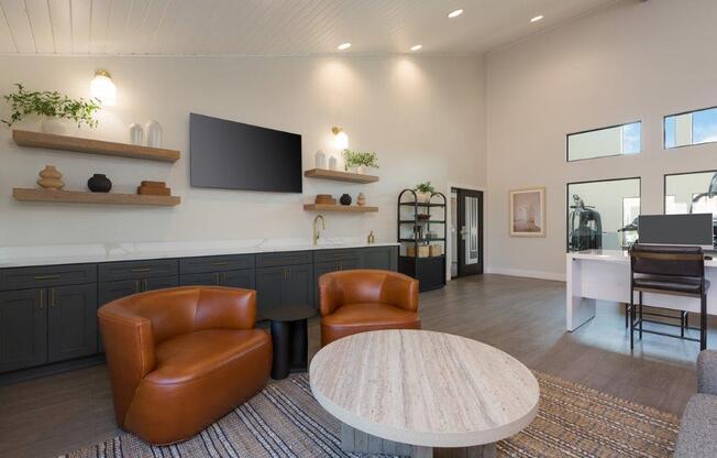 a living room with two leather chairs and a table