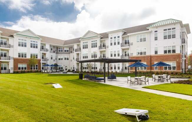 Building exterior with sitting area and lawn at 99 Bridge, New Jersey, 08857
