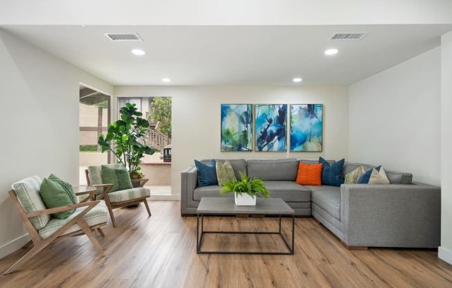 a living room with white walls and hardwood flooring