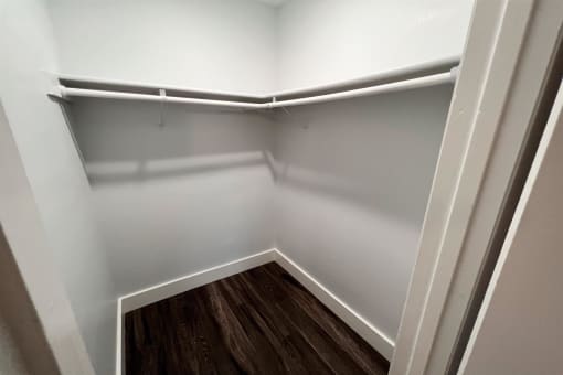 the preserve at ballantyne commons empty closet with wood floor and white walls