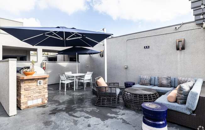 A patio with a table, chairs, and a sofa.