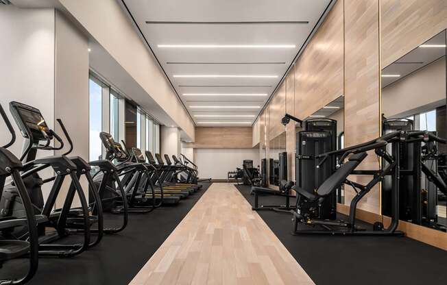the gym is equipped with a variety of exercise equipment at The Paxton, Brooklyn, New York