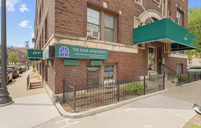 a building with a green awning and a sign that reads the park condominiums