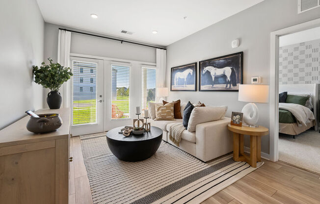 A modern living room with a large window and a view of a building outside at Madison Prickett Preserve, Pennsylvania