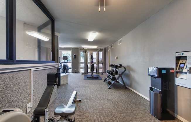 The fitness center with rowing machine, elliptical, treadmill, bike, weight system and free weights at Cambridge Court Apartments in Lake Highlands, Dallas, TX.