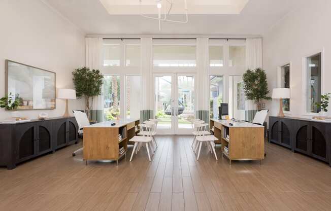 a living room with wooden floors and a table and chairs