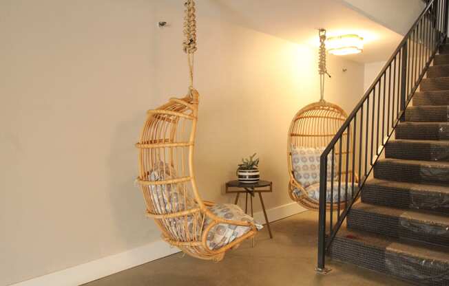 a hammock swing in a living room next to a staircase