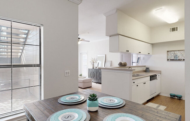 a kitchen and dining room with a table and chairs