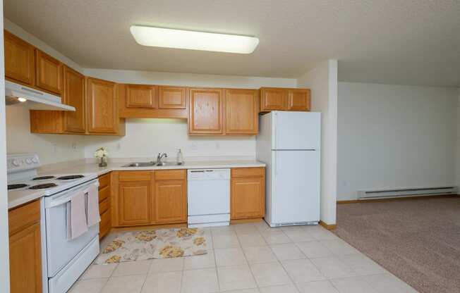 A kitchen with white appliances. Pinehurst Apartments | 2 Bedroom Plan D | Kitchen