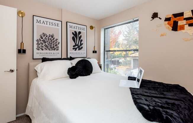 a bedroom with a large white bed and a window