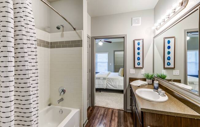 Master bathroom with double vanity and garden tub at Avenues at Craig Ranch apartments for rent in Dallas, TX