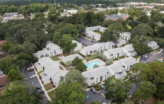 A bird's eye view of a residential area with a swimming pool.