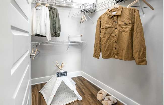 a walk in closet with a jacket hanging on the wall at The Overlook, Winter Garden, FL