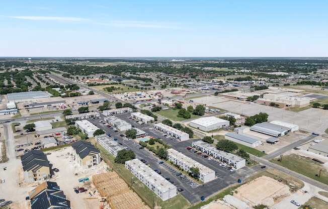 an aerial view of a city with buildings and cars at Brookside Apartments, Hewitt, Texas