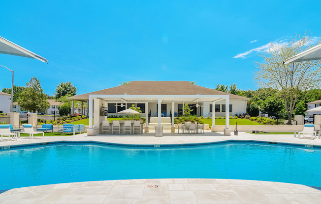 a swimming pool with a house in the background