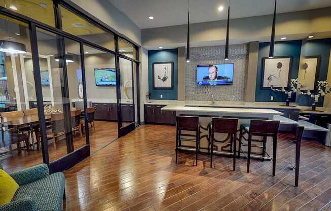 A room with a bar and chairs.