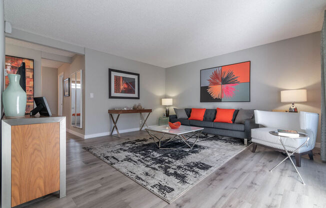 a living room with a couch and a tableat Sunnyvale Crossings Apartments, LLC, Sunnyvale, CA