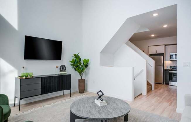 a living room with a tv and a table