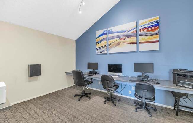 A room with a blue wall and a painting on it at Urban WalkApartments on 6th Avenue, Phoenix