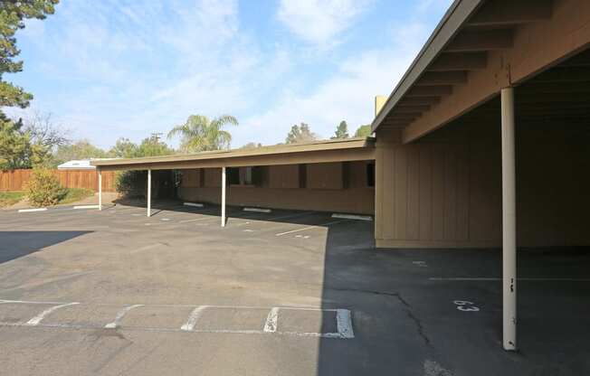 A parking lot with a building in the background.