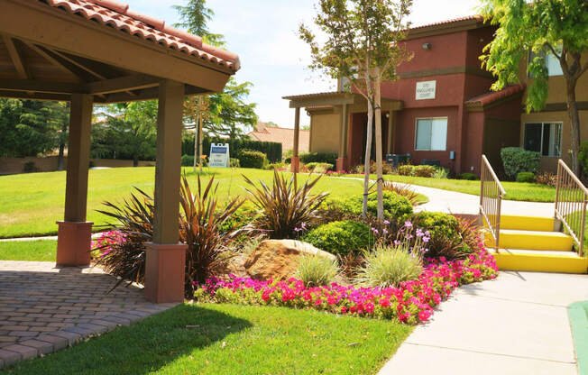 Apartments in Antelope Valley CA - The Arches at Regional Center West - Kitchen with Black Appliances and Wood-Style Flooring