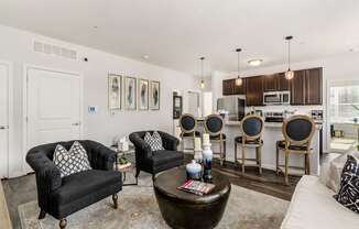 A living room with a black couch and a coffee table.