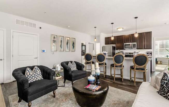A living room with a black couch and a coffee table.