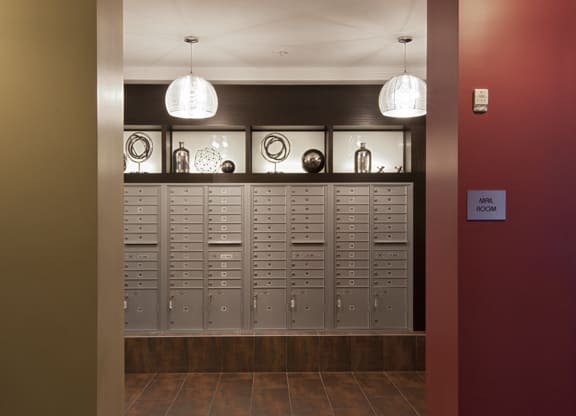 a view of the lockers in a building with a red wall