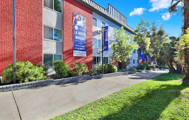 A red building with a blue sign that says "La Favorite Marquise".