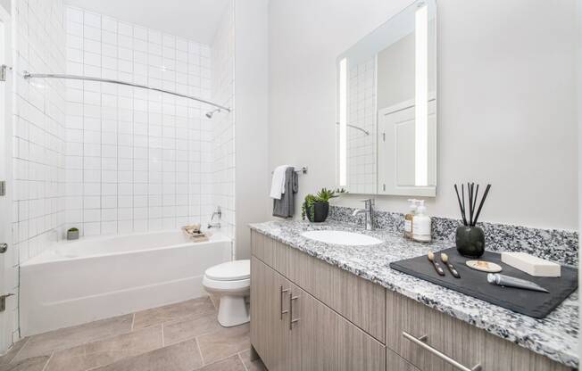 a bathroom with a sink and a toilet and a shower at The Baxly, Savannah, GA