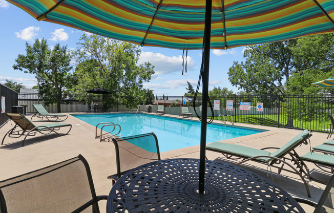 our apartments have a swimming pool with chairs and umbrellas