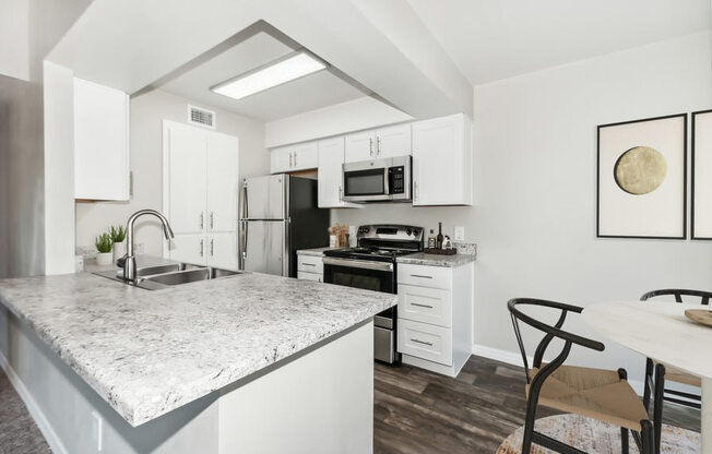 Model kitchen with white cabinetry