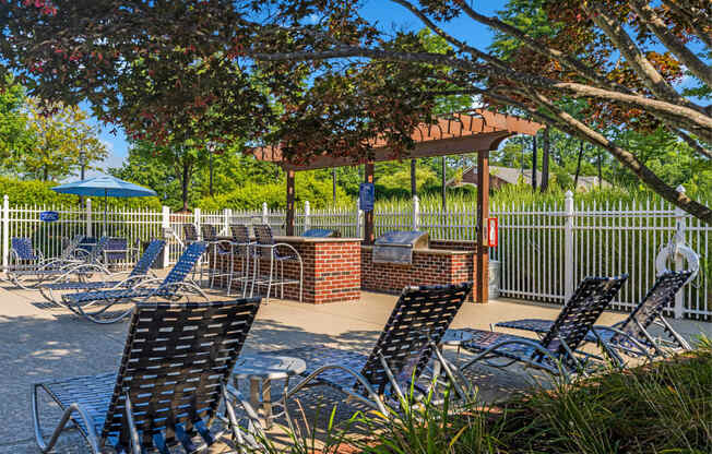 a patio with chairs and tables and a gazebo