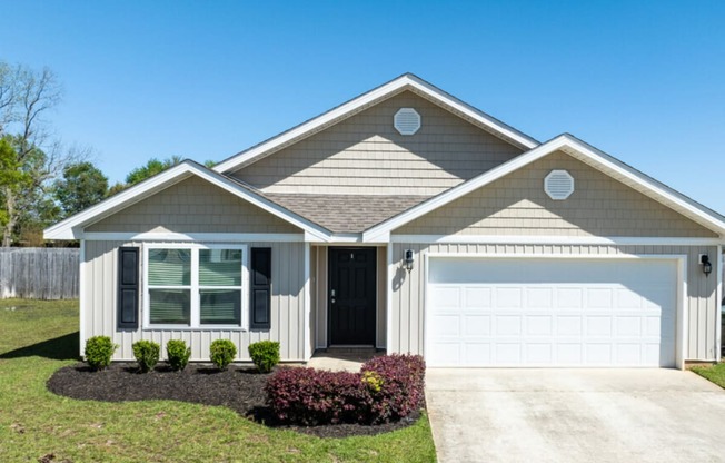 a house with a white garage door and a lawn