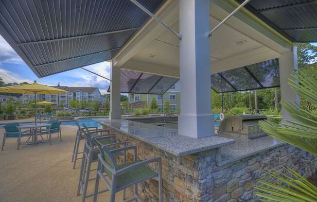 Poolside kitchen with bar-style seating at Lullwater at Blair Stone