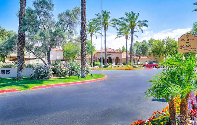 A street view of a residential area with a sign that reads