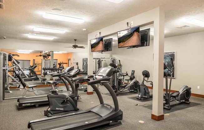 Expansive 24-hour fitness center with cardio equipment, TVs and more at Villas of Omaha townhome apartments in northwest Omaha NE 68116