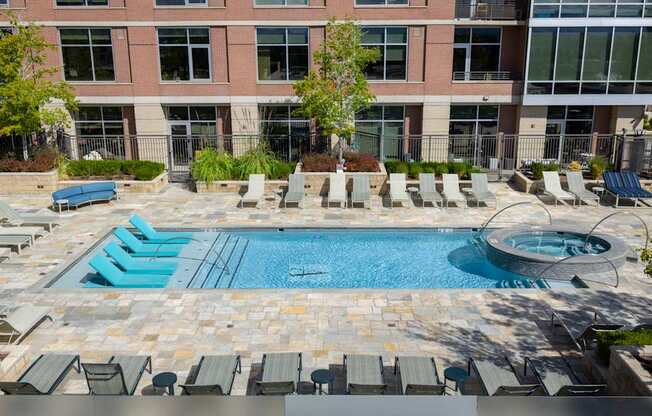 A large swimming pool surrounded by lounge chairs.