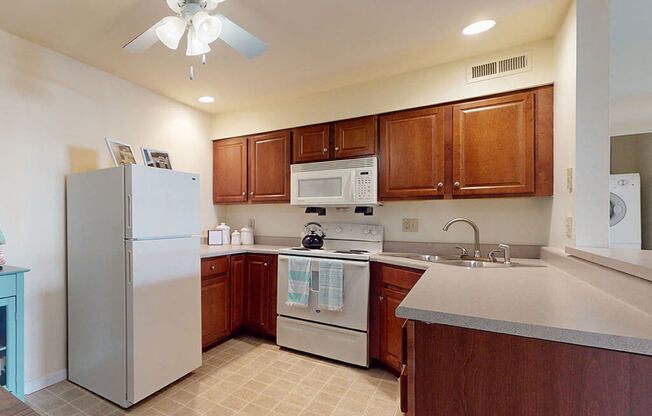 a kitchen with stainless steel appliances and a refrigerator