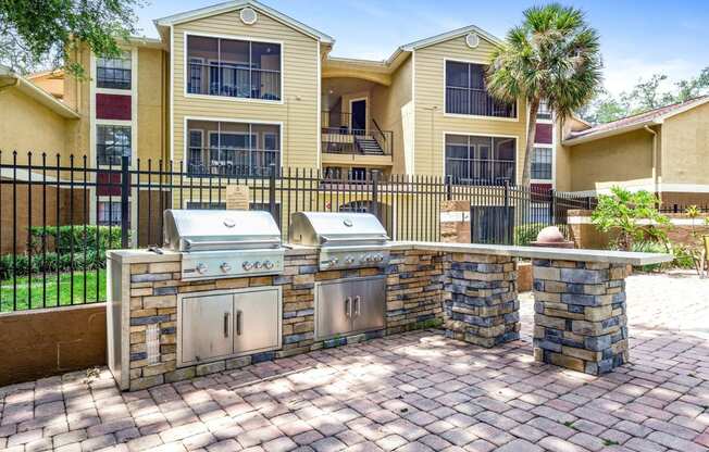 a backyard with two stainless steel appliances in front of a house