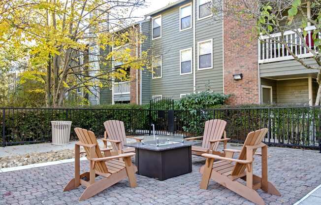 our apartments have a patio with chairs and a fire pit