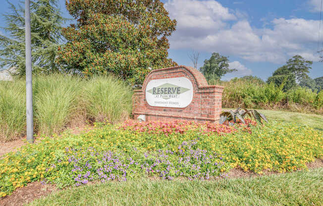 A sign that says Reserve is in front of a grassy area.