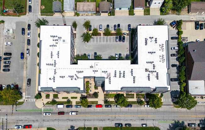 A large white building with a parking lot in front.