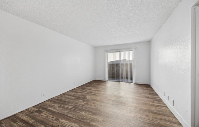 Madera at Metro  A room with wooden flooring and white walls.