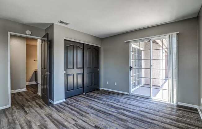 the living room of a new home with doors and a window